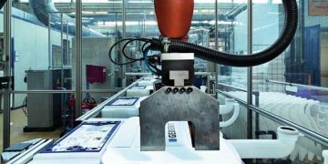 Robot fabricant les réservoirs de chasse dans une usine Geberit